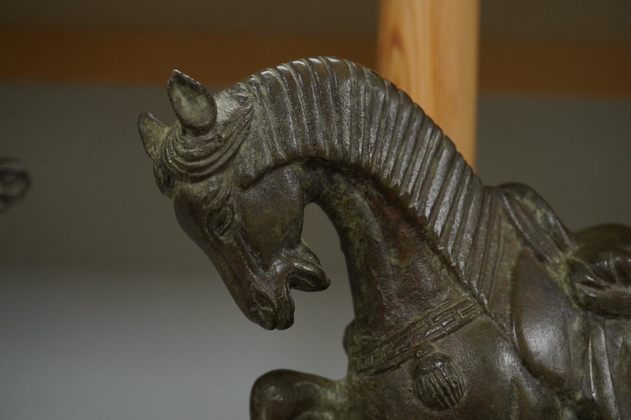 A Chinese bronze figure of a horse, Tang style, signed to the base, 24cm high. Condition - good